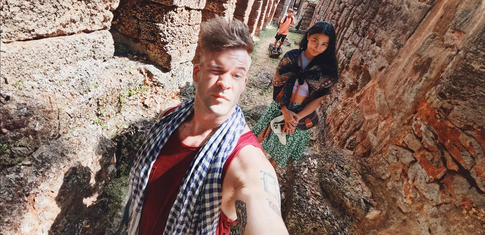 thefruitbox owners, white male and asian female standing in ancient city ruins with small boy